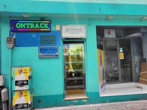 A hotel with a sign for 'ONTRACK' indicating a 4th-floor home stay option.