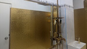 A bathroom with a shower, a sink, and a door. - TRANSIT HOTEL  LUXUARY (Male)