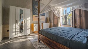 A bedroom with a canopy bed, a wardrobe, and a large window. - Kokokan Villa Ubud (Gianyar)