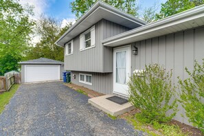 A two-story house with a garage, a driveway, and a small garden area. - 2 Mi to I-88 & Hospital! Extended Naperville Stay (Naperville)