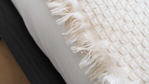 A close-up of a bed with a white blanket and a dark-colored headboard. - In the Heart of Ghent | Charming Private Room (Ghent)