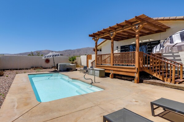 A backyard with a swimming pool, wooden deck, and outdoor seating. - Home w/ Outdoor Oasis & Views in Borrego Springs! (Borrego Springs)