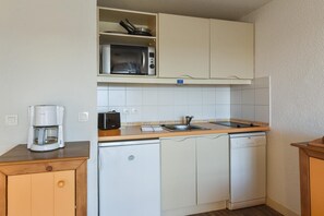 A compact kitchen with a microwave, coffee maker, sink, and dishwasher. - Scenic Mountain View Apartment for 2 (Font Romeu Ermitage)