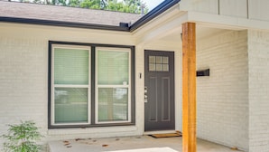 A house with a front door, a window, and a porch. - 2 Mi to OKC Fairgrounds: Pet-Friendly Home w/ Yard (Oklahoma City)