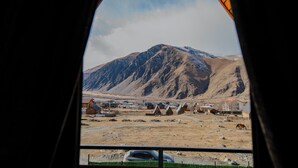 A mountainous landscape with a view of a small settlement, including houses and a road. - Welcome to our property ❤️ Cozy house in mountains (Stepantsminda)