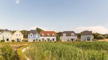 A row of houses with a pathway leading through a field.