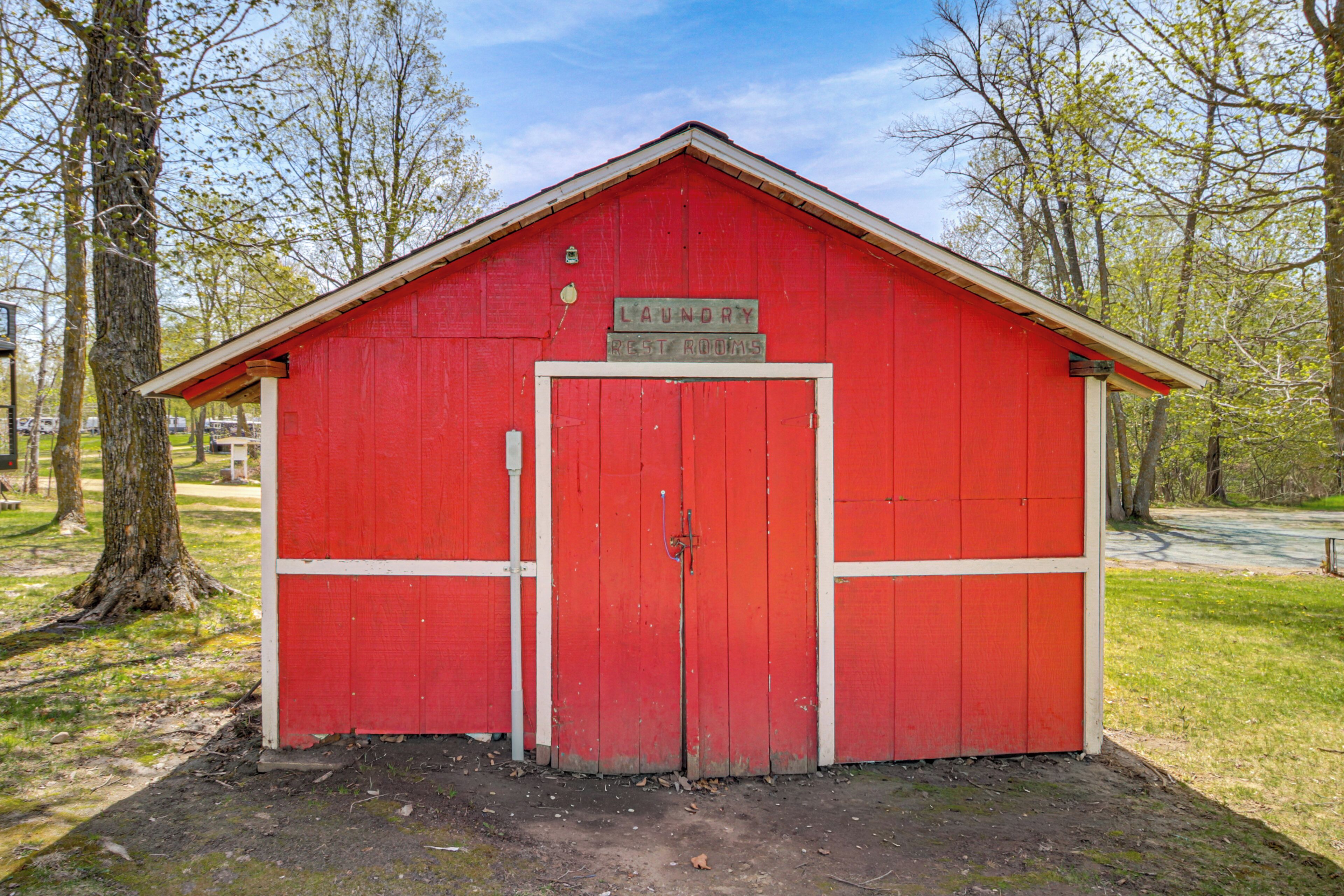 A red building with a sign that reads 'Laundry Rest Rooms.'