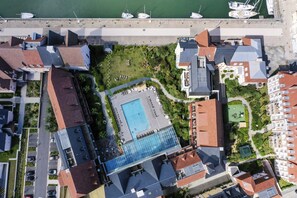 An aerial view of a hotel with a swimming pool, adjacent to a marina with boats. - Picturesque Deauville Apartment for 6 (Deauville)