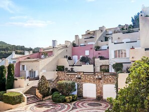 A hillside village with traditional stone buildings, terraced roofs, and a circular mosaic courtyard. - Hameau la Madrague by Interhome (Saint Cyr sur Mer La Madrague)