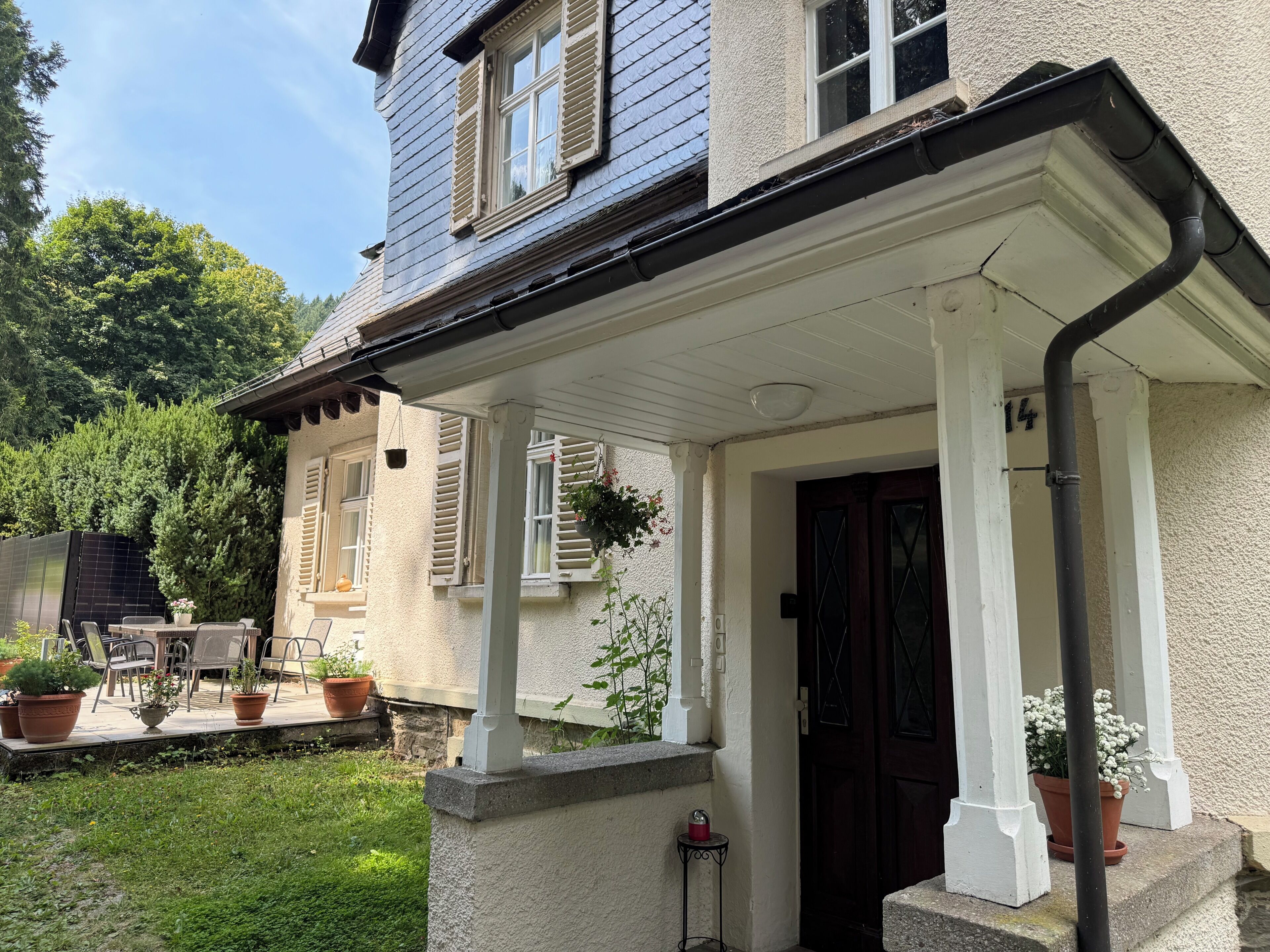 A house with a porch, a door, and a window.