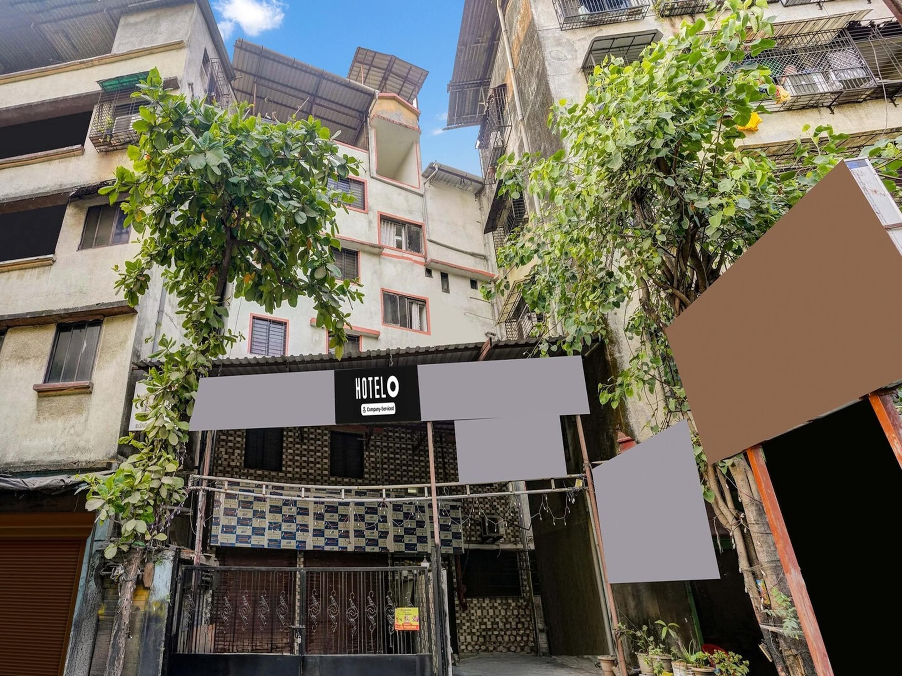 Η είσοδος ενός ξενοδοχείου με μια πινακίδα που γράφει «ΞΕΝΟΔΟΧΕΙΟ» και μια πύλη στην είσοδο.