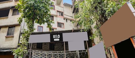 A hotel entrance with a sign reading 'HOTEL' and a gated entrance.