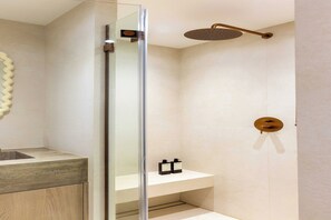 Ein modernes Badezimmer mit Duschkabine aus Glas, einem Holzbadezimmer-Möbel und einem minimalistischen Design.