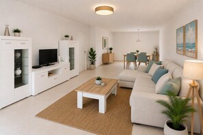 A modern living room with a sofa, coffee table, TV, and dining area. - Max Apartment with communal garden and pool (Roquetas de Mar)