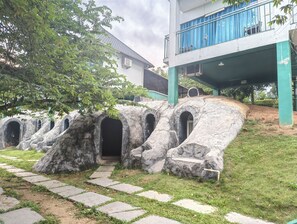 A building with a stone pathway leading to a series of arched openings.