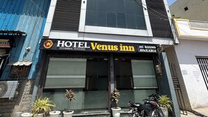 A hotel named 'Venus Inn' with a sign indicating 'AC Rooms Available.' - Hotel Venus Inn (Indore)