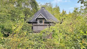 A small, rustic cabin surrounded by dense foliage. - Birch Lodge at Aos Sí (Ballachulish)