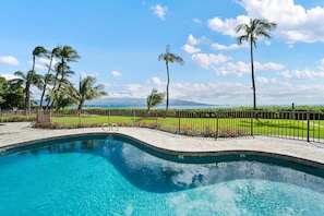 A swimming pool with a view of the ocean and palm trees. - Remodeled Oceanfront 1BD with Stunning Sunset Views- Maalaea Banyans 316 (Wailuku)