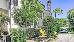 A residential area with a white building, a yellow fire hydrant, and a gravel driveway. - La Tana by Interhome (Castiglioncello)