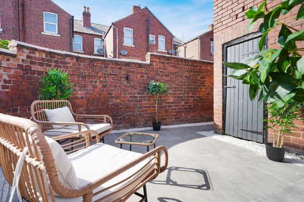 Comfortable outdoor seating makes this patio area a welcoming spot for spending time outside during your stay. The enclosed surroundings and practical layout create a relaxed setting for catching up or unwinding.