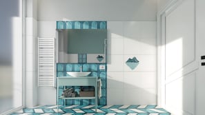 A bathroom with a white sink, a mirror, and a tiled floor with a geometric pattern. - Palazzo M (Sorrento)