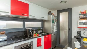 Una cocina moderna con estufa, horno, refrigerador y microondas.