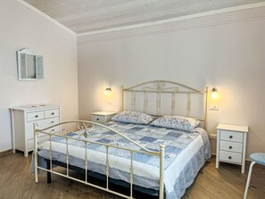 A bedroom with a bed, two bedside tables, a nightstand, a dresser, and a mirror. - Pierina by Interhome (Finale Ligure)