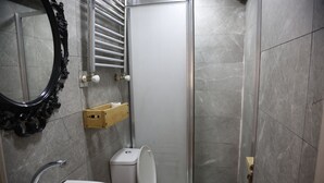 A bathroom with a toilet, sink, and a shower area. - BRK DREAM SUITS (Istanbul)