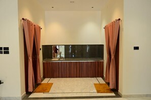 A bathroom with a vanity, a mirror, and a shower area. - 4-bedroom bungalow in marvelous Isarwarpur with cool AC (Isarwarpur)