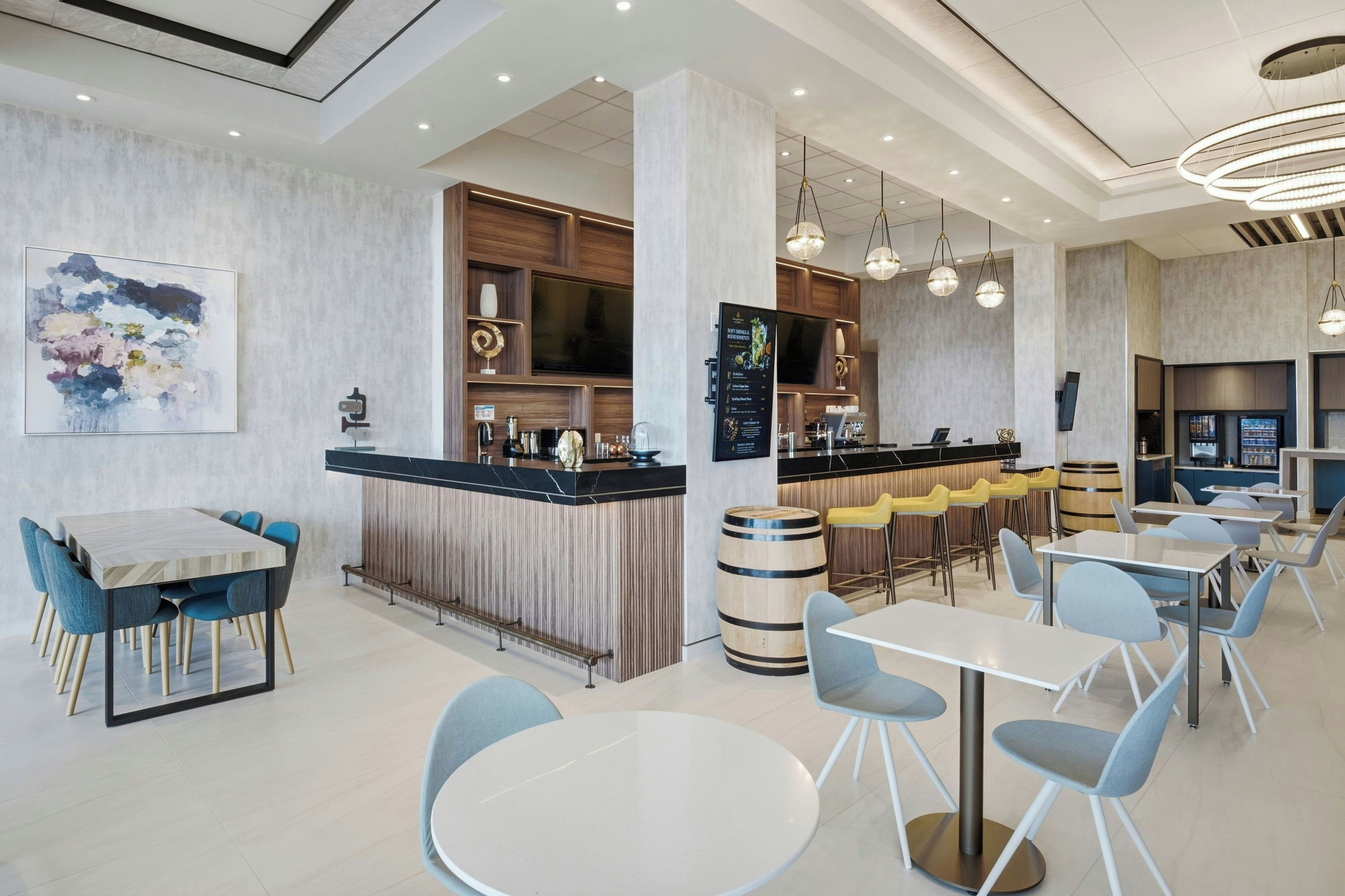 A modern restaurant interior with a bar area, seating arrangements, and a large abstract painting on the wall.