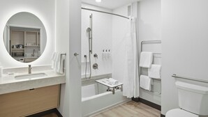 A modern bathroom with a built-in shower, a vanity with a mirror, and a toilet. - TownePlace Suites by Marriott Vaughan (Vaughan)
