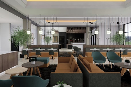 A modern interior with seating areas, tables, hanging pendant lights, and large windows.