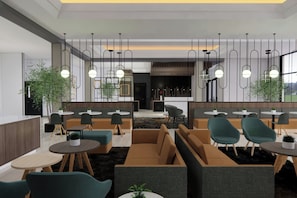 A modern interior with seating areas, tables, hanging pendant lights, and large windows. - TownePlace Suites by Marriott Vaughan (VAUGHAN)