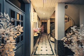 A hotel hallway with a 'ROYAL' sign, a tiled floor, and a staircase. - Royal Hotel (Cairo)