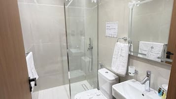 Separate tub and shower, hair dryer, slippers, towels