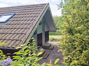 A house with a sloped roof, a skylight, and a small porch. - 8 Person Holiday Home in Bogo By (Bogø By)