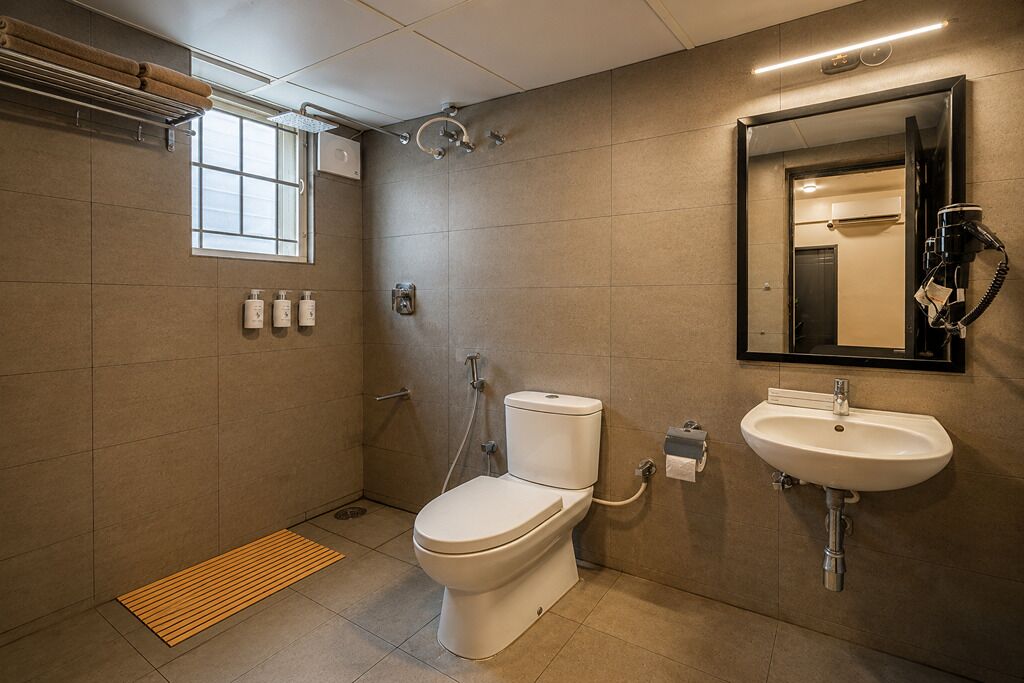 A modern bathroom with a toilet, sink, and shower.