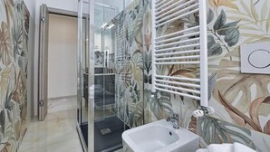 A bathroom with a glass shower enclosure, a white sink, and a towel rack. - GIOIA E RELAX DI ZR  (Rho)