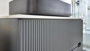 A modern, metallic air conditioning unit with a vent and a handle, part of a building's exterior. - GIOIA E RELAX DI ZR  (Rho)