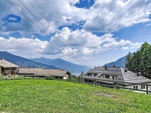 A rural landscape with houses, a field, and mountains in the background. - Ciasina Alpina by Interhome (Folgarida)