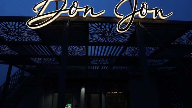 A building with a prominent illuminated sign reading 'Don Jon' and a decorative metal structure. - Moresta Ajmer Hotel with Rooftop Bar (Ajmer)