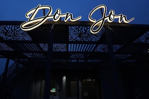 A building with a prominent illuminated sign reading 'Don Jon' and a decorative metal structure. - Moresta Ajmer Hotel with Rooftop Bar (Ajmer)