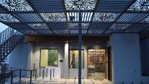 A modern building with a patterned ceiling, a glass door entrance, and a tiled floor. - Moresta Ajmer Hotel with Rooftop Bar (Ajmer)