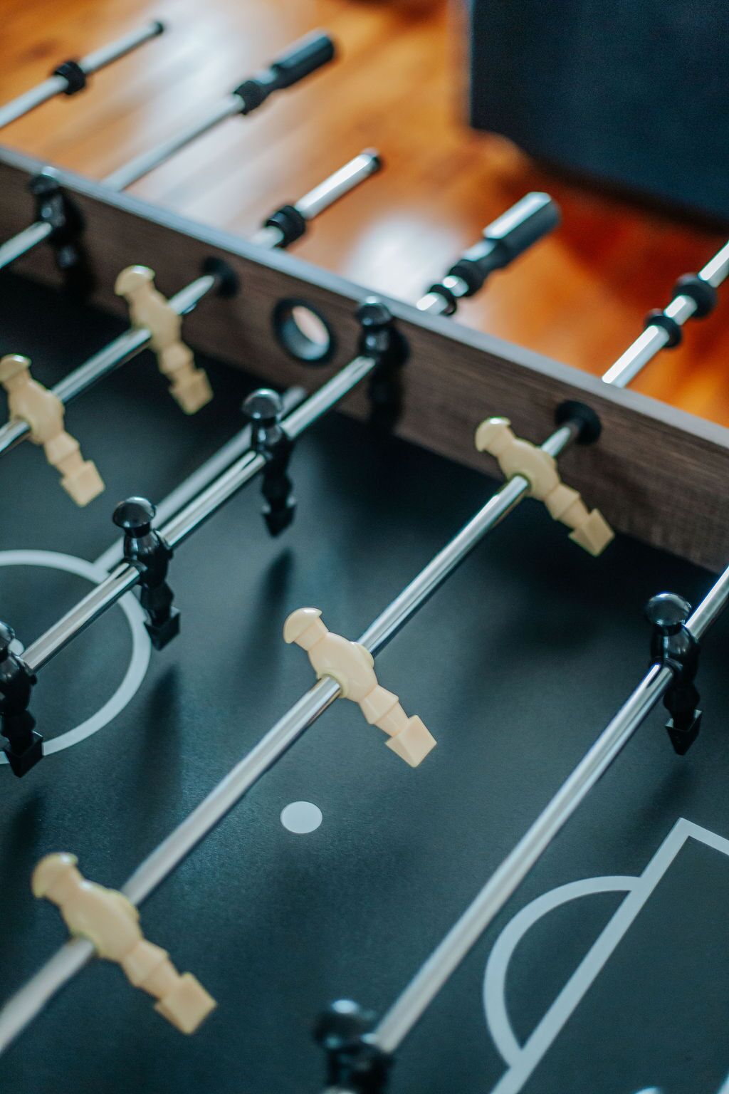 A close-up of a foosball table with rods and figures.