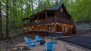 Een chalet met terras, buitenmeubels en een jacuzzi.