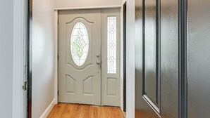 A closed door with a glass panel and a doorbell.