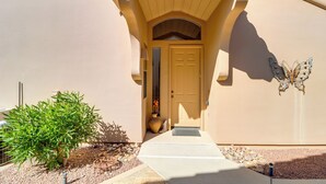 A house with a beige exterior, a front door, a butterfly decoration, and a small tree. - Golf, Hike & Unwind: Oro Valley Townhome w/ Patio! (Oro Valley)
