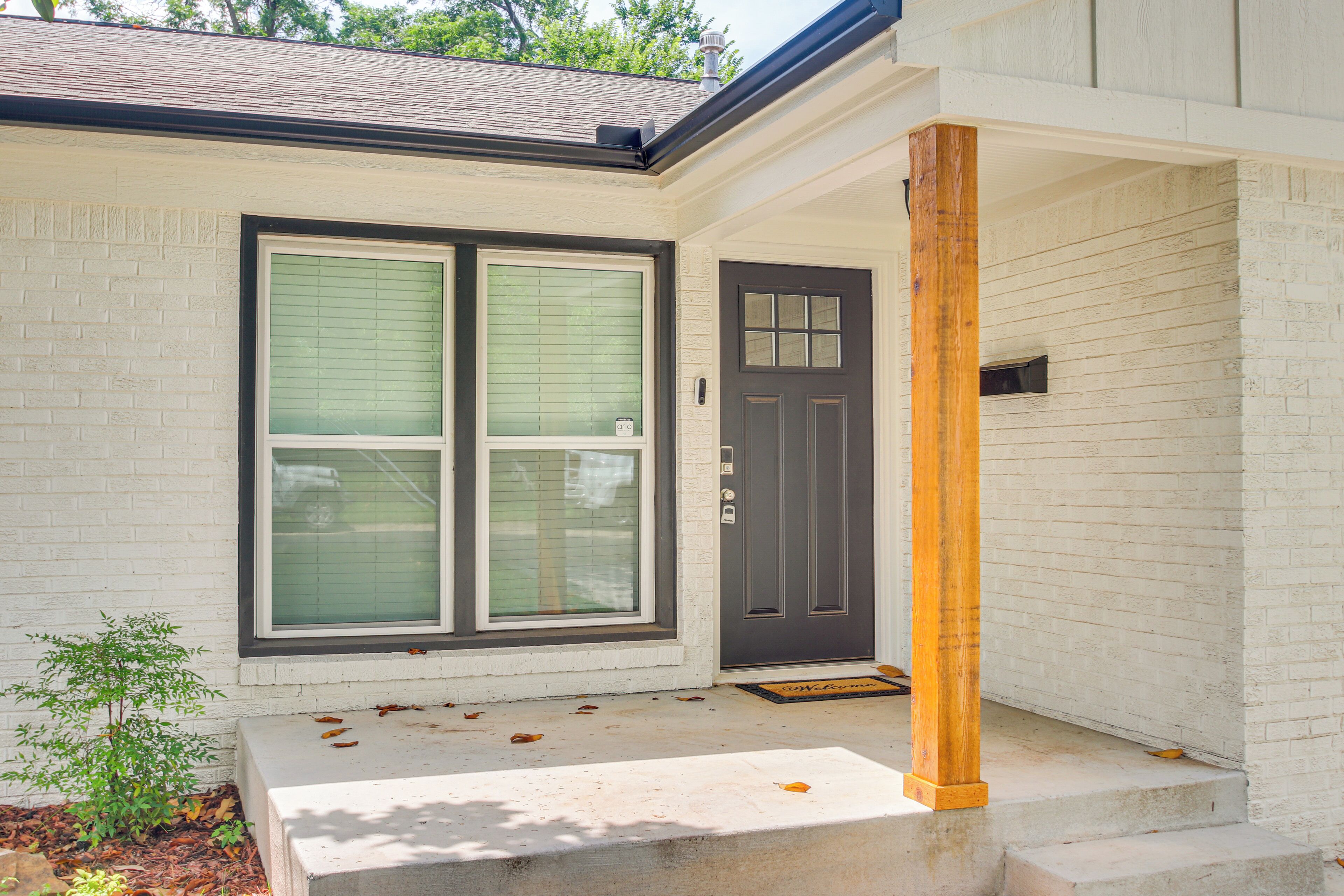 A house with a front door, a window, and a porch.