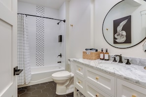 A bathroom with a bathtub, toilet, and vanity with a mirror and sink. - Front Range, Rocky Mtn Nat'l Park Base: Golf Views (Loveland)