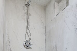 A shower with a handheld hose in a room with white marble walls. - Near Southern Regional MC! Commuter-friendly Base (Riverdale)